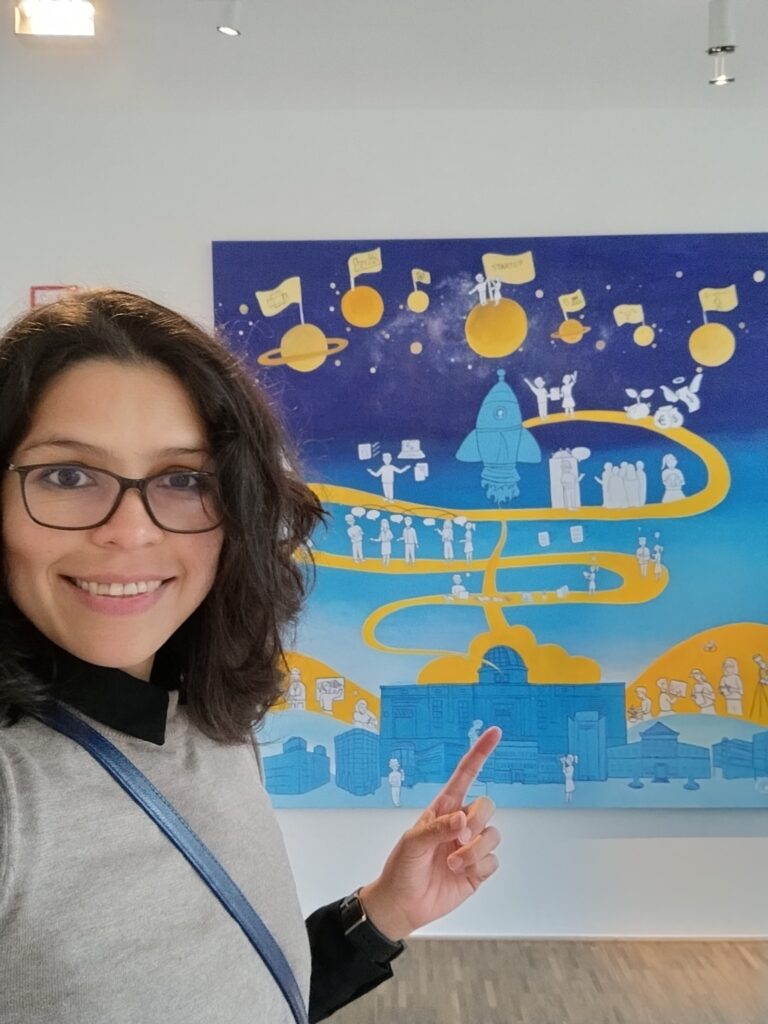 Beatriz Herrera Campo, pointing to artwork in the final location